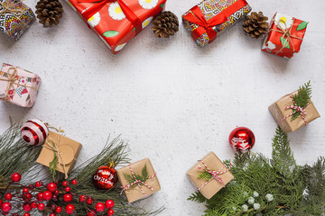 Christmas background with decorations and gift boxes on wooden board.