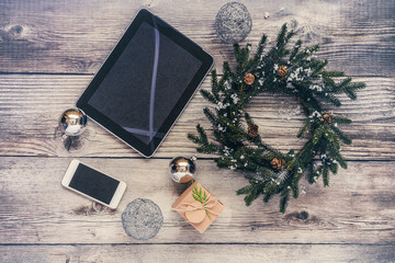 Christmas background with decorations and gift boxes on wooden board.