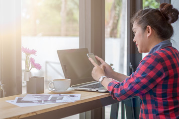 Close Up businessmen working at a coffee shop with a document with a smartphone and a laptop computer.
