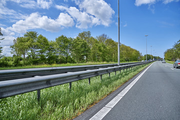 crush barrier on empty urban highway with grass