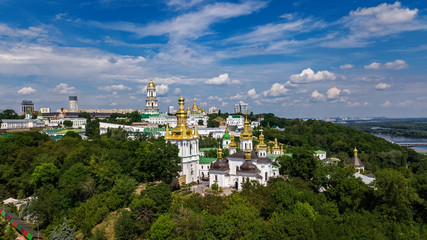 Aerial top view of Kiev Pechersk Lavra churches on hills from above, cityscape of Kyiv city, Ukraine
