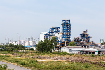 Refinery tower in petrochemical industrial plant with blue sky