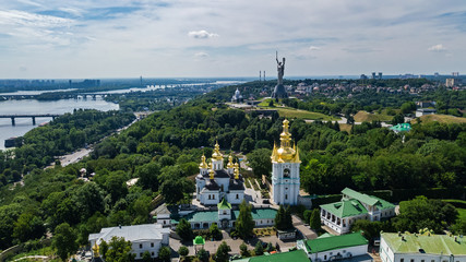 Fototapeta na wymiar Aerial top view of Kiev Pechersk Lavra churches on hills from above, cityscape of Kyiv city, Ukraine 