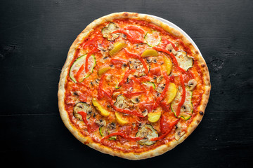 Vegetable Vegetarian Pizza. On a wooden background. Top view. Free space for text.