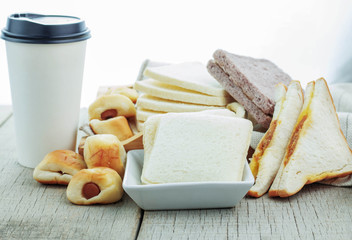 breads and coffee cups on wooden.