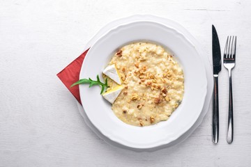 Risotto with cheese on a wooden background. Top view. Free space for text.