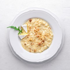 Risotto with cheese on a wooden background. Top view. Free space for text.