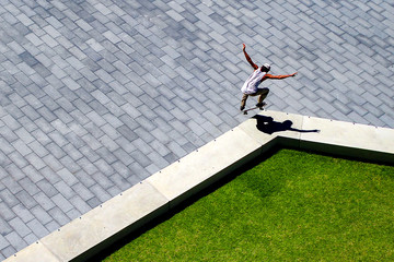 perfectly timed aerial view of skateboarder with crisp shadow © Wayne