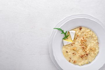 Risotto with cheese on a wooden background. Top view. Free space for text.