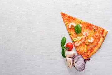 Pizza with shrimp. On a wooden background. Top view. Free space for text.