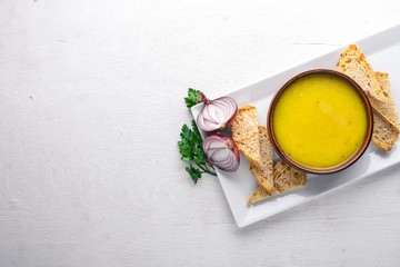 Pea and corn puree soup. On a wooden background. Top view. Free space for text.