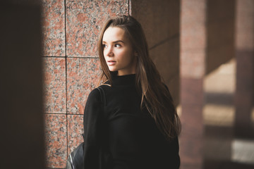 Portrait of a young beautiful woman in a urban background