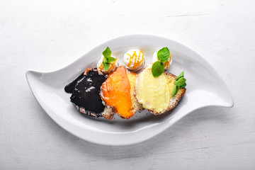 Biscuit pastry with caramel and chocolate sauce. On a wooden background. Top view. Free space for text.