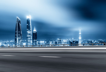 empty road with cityscape of modern city in cloud sky