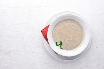 Mushroom puree soup. On a wooden background. Top view. Free space for text.