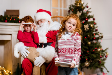 Obraz na płótnie Canvas santa claus and children with digital devices