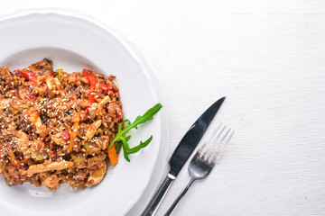 Chinese cuisine. Chicken fillet in tomato sauce on a wooden background. Top view. Free space for text.