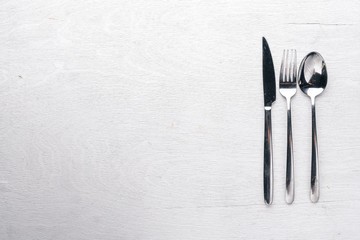 Cutlery on a wooden background. Top view. Free space for text.