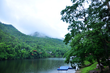 Fototapeta premium Camping area along side Khwae Yai River at Erawan waterfall - Kanchanaburi, Thailand