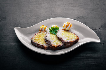 Biscuit pastry with caramel and chocolate sauce. On a wooden background. Top view. Free space for text.