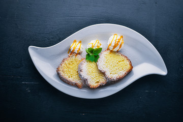 Biscuit pastry with caramel and chocolate sauce. On a wooden background. Top view. Free space for text.