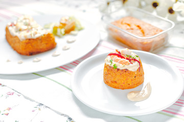 Traditional fish cake. Hake cake with tomato, shrimps and salad cream on Flower table cloth.