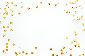 Mock up frame with space for text made of golden confetti on white background. Flat lay, top view....