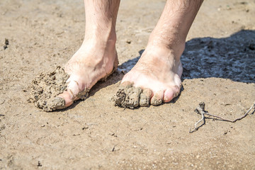 Feet in the mud on the beach