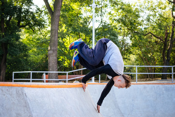 Young man doing parkour tricks in extreme sports park