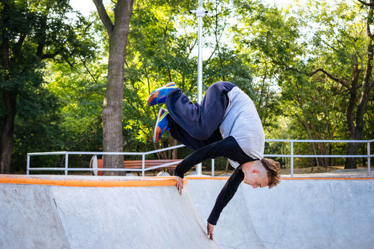 Young man doing parkour tricks in extreme sports park - Powered by Adobe