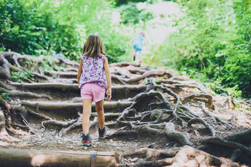 Children - twin girls are hiking in the mountains.