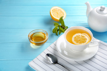 Beautiful composition with cup of cinnamon tea on wooden table