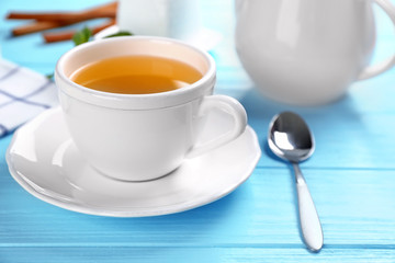 Beautiful composition with cup of cinnamon tea on wooden table