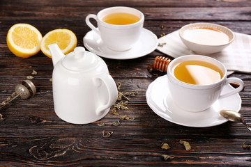 Obraz na płótnie Canvas Beautiful composition with cups of cinnamon tea on wooden table