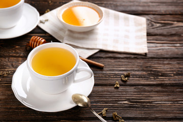 Beautiful composition with cup of cinnamon tea on wooden table