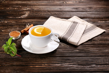 Beautiful composition with cup of cinnamon tea on wooden table