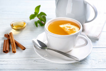 Beautiful composition with cup of cinnamon tea on wooden table