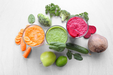Fresh juices in glasses and ingredients on table