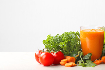 Fresh juice in glass and ingredients on white background