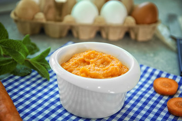 Ramekin with tasty carrot souffle on table