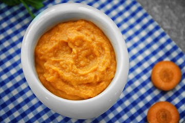 Ramekin with tasty carrot souffle on table
