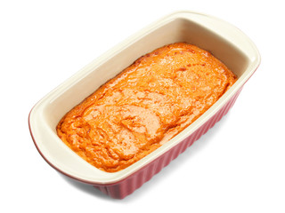 Baking dish with tasty carrot souffle on white background