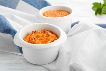 Ramekins with tasty carrot souffle on wooden table