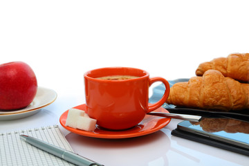 Coffee still life with an orange mug and phone