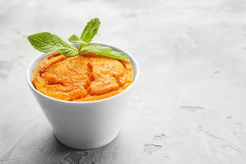 Ramekin with tasty carrot souffle on table