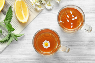 Composition with cups of chamomile tea  on table