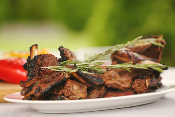Delicious ribs served for dinner on table
