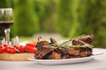 Delicious ribs served for dinner on table