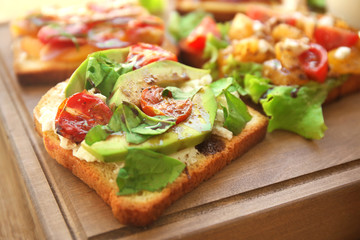 Tasty sandwiches on wooden board, closeup