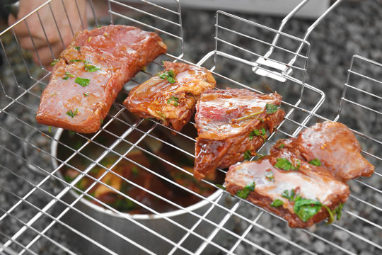 Appetizing juicy spare ribs on bbq grid outdoors